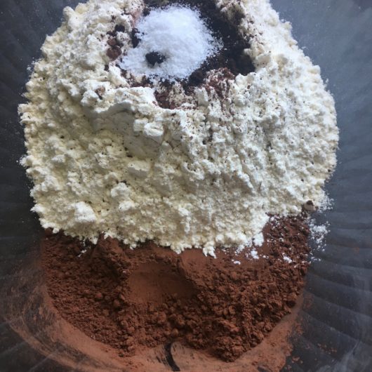 cocoa powder, flour, salt, baking powder, and espresso measured into a glass mixing bowl