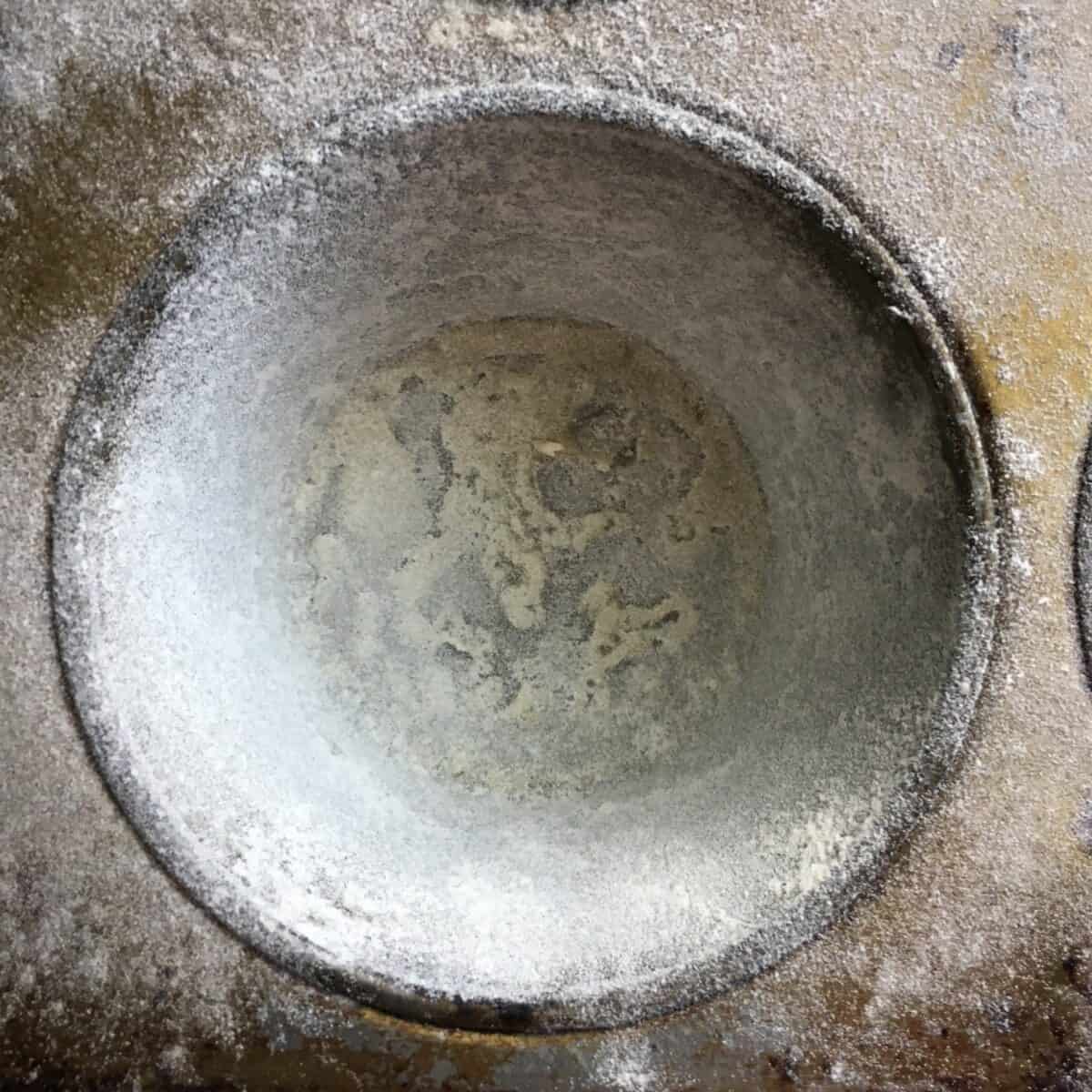 Buttered and floured cake pan ready for devil's food cake batter