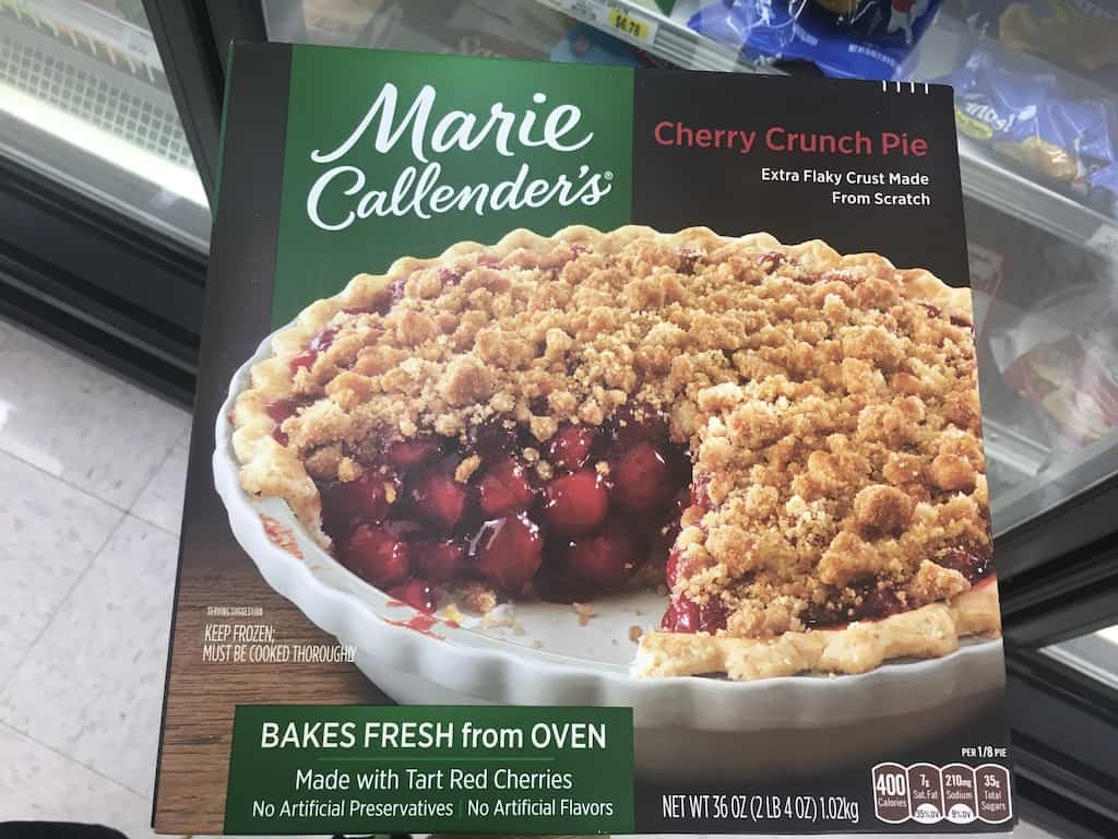 a box of frozen Marie Callender's Cherry Crunch Pie at the grocery store I'm holding in my hand