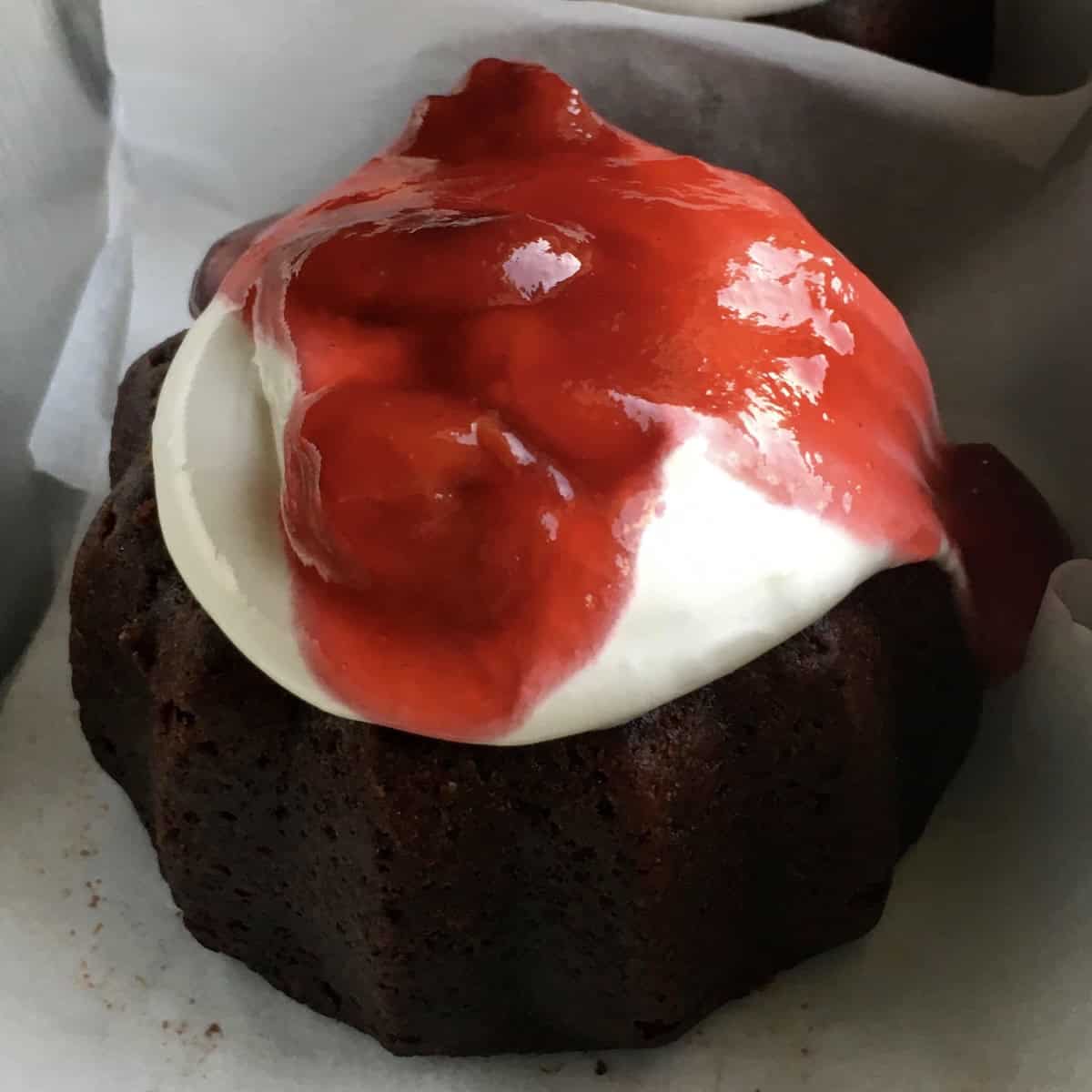 Devil's food cake black forest mini bundt cake with homemade cherry pie filling over fluffy 7-minute frosting, a creative devil's food cake recipe idea combining moist devil chocolate cake with classic black forest flavors.