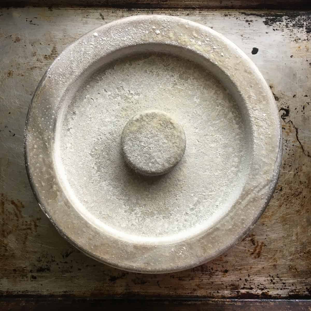 Cake pan prepared with butter and flour for the first step in how to make devil's food cake from scratch, showing the proper way to prep pans for this moist devil food cake recipe (cake pan used for make homemade ding dong cake)
