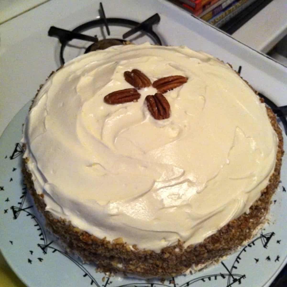 Homemade double layer red velvet cake with cream cheese frosting and toasted pecans