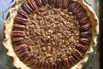 perfectly baked golden brown pecan pie on a metal sheet tray