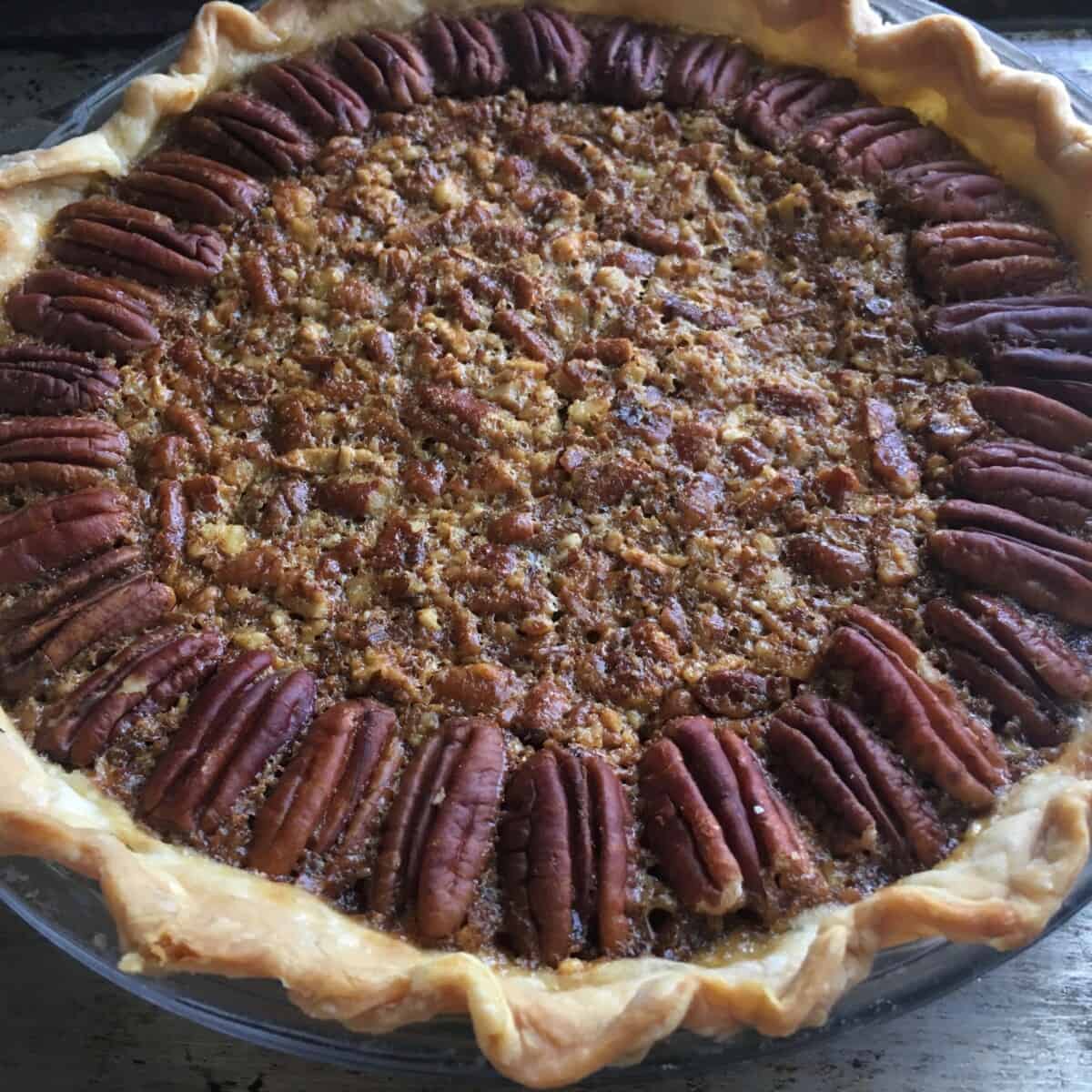 baked and rested golden brown pecan pie with a super flaky crust