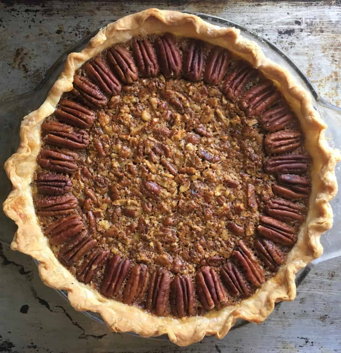 Golden brown pecan pie on a half sheet pan.