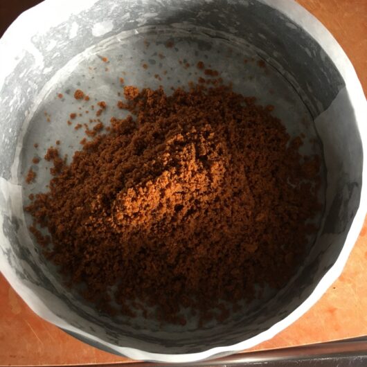 a mound of cookie-butter mixture in springform pan
