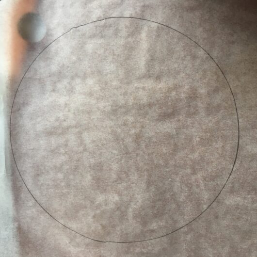 using the springform pan, draw a circle around the it on parchment paper