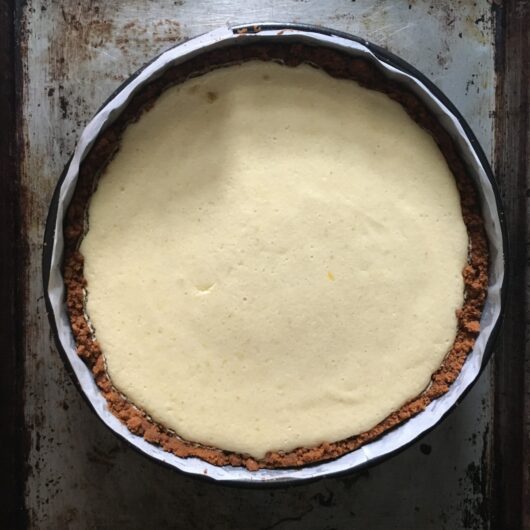 a whole and beautiful key lime pie baked in a spring from cake pan