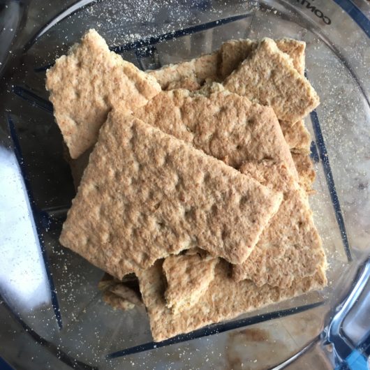 closeup view of graham crackers in vitamix dry container ready to be chopped