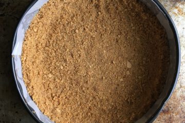 graham cracker crust in 9 inch springform cake pan ready to be filled