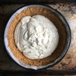 a mound of cream cheese batter in the middle of the cookie crust before being smoothed out