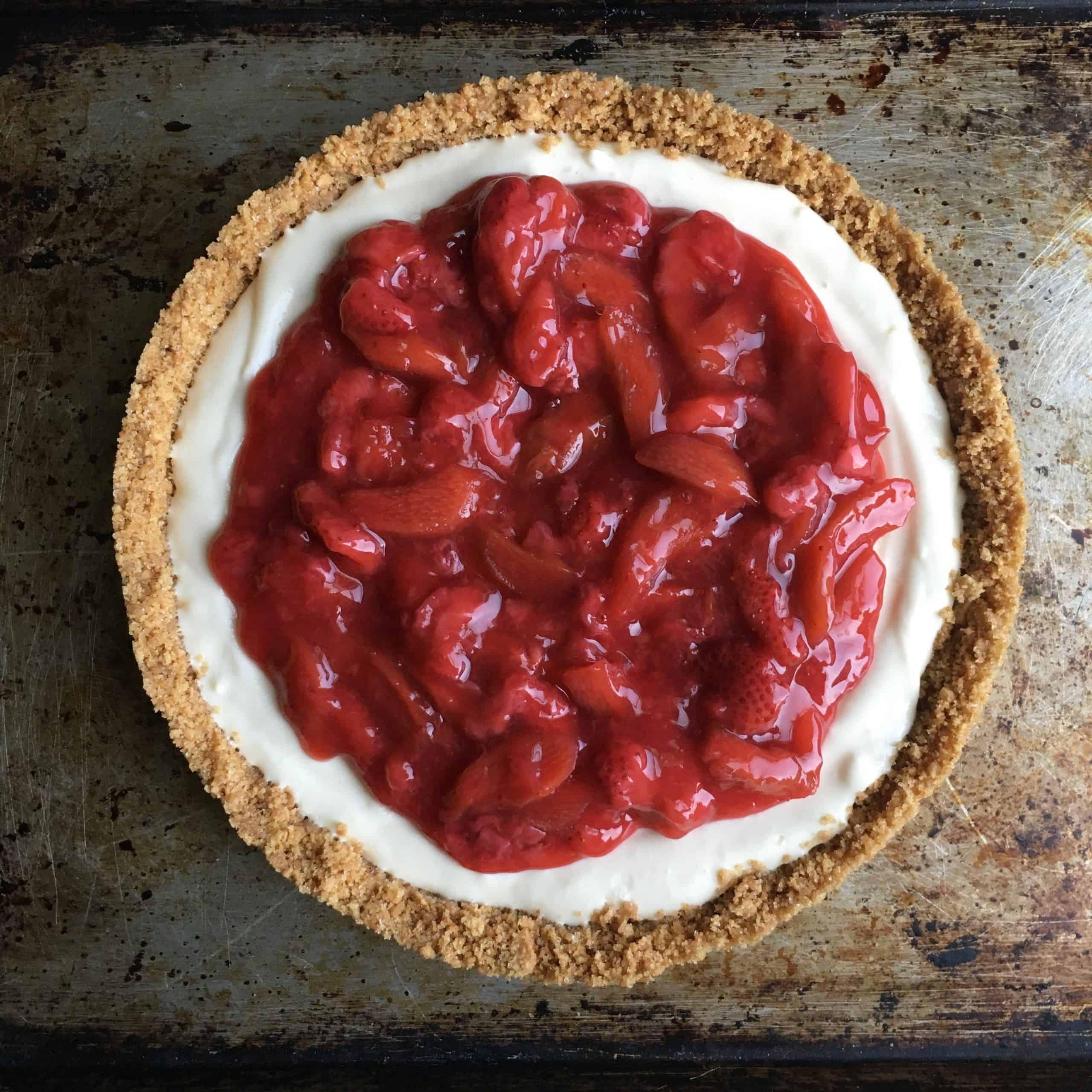 strawberry-rhubarb cream cheese pie on a sheet pan