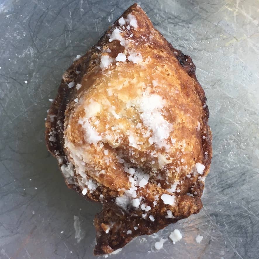 a single fried cherry pie wonton in a vintage pie plate
