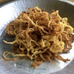 a pile of fried onion ring strings