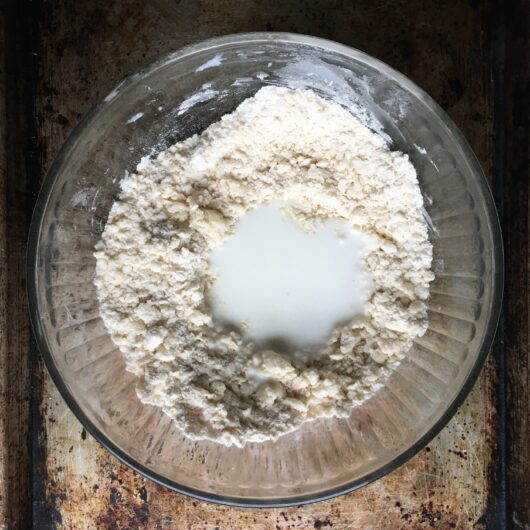 flour and lard mixture with a pool of buttermilk in the center