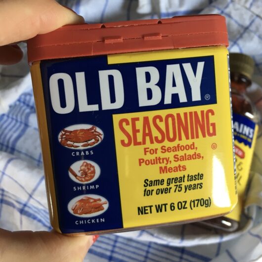 Old Bay Seasoning Box held by a hand