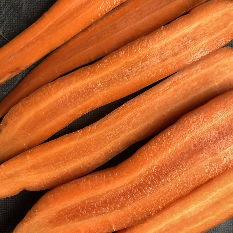raw carrots sliced in half revealing only the inner core