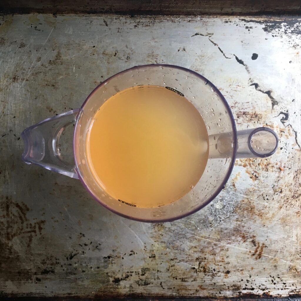vinegar in a liquid measuring cup on a sheetpan