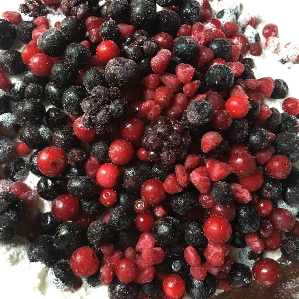 a pile of frozen frutti di bosco with raspberries, blueberries, blackberries and red currants