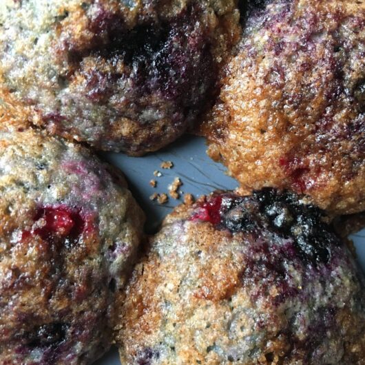 closeup of the blue, purple and red tops of the very berry muffins