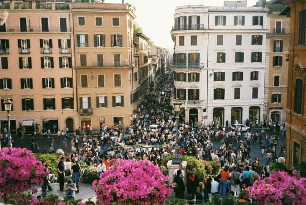 a view from the Spanish Steps looking down onto the main shopping drag of Rome