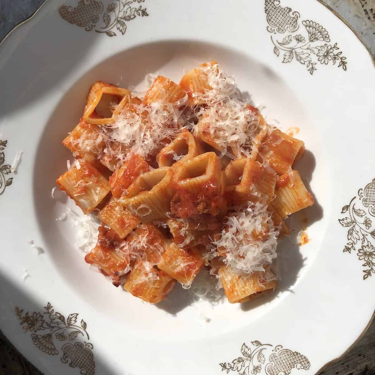 Amatriciana with Verrigni soqquadro pasta in bowl, authentic pasta amatriciana recipe with guanciale and pecorino.