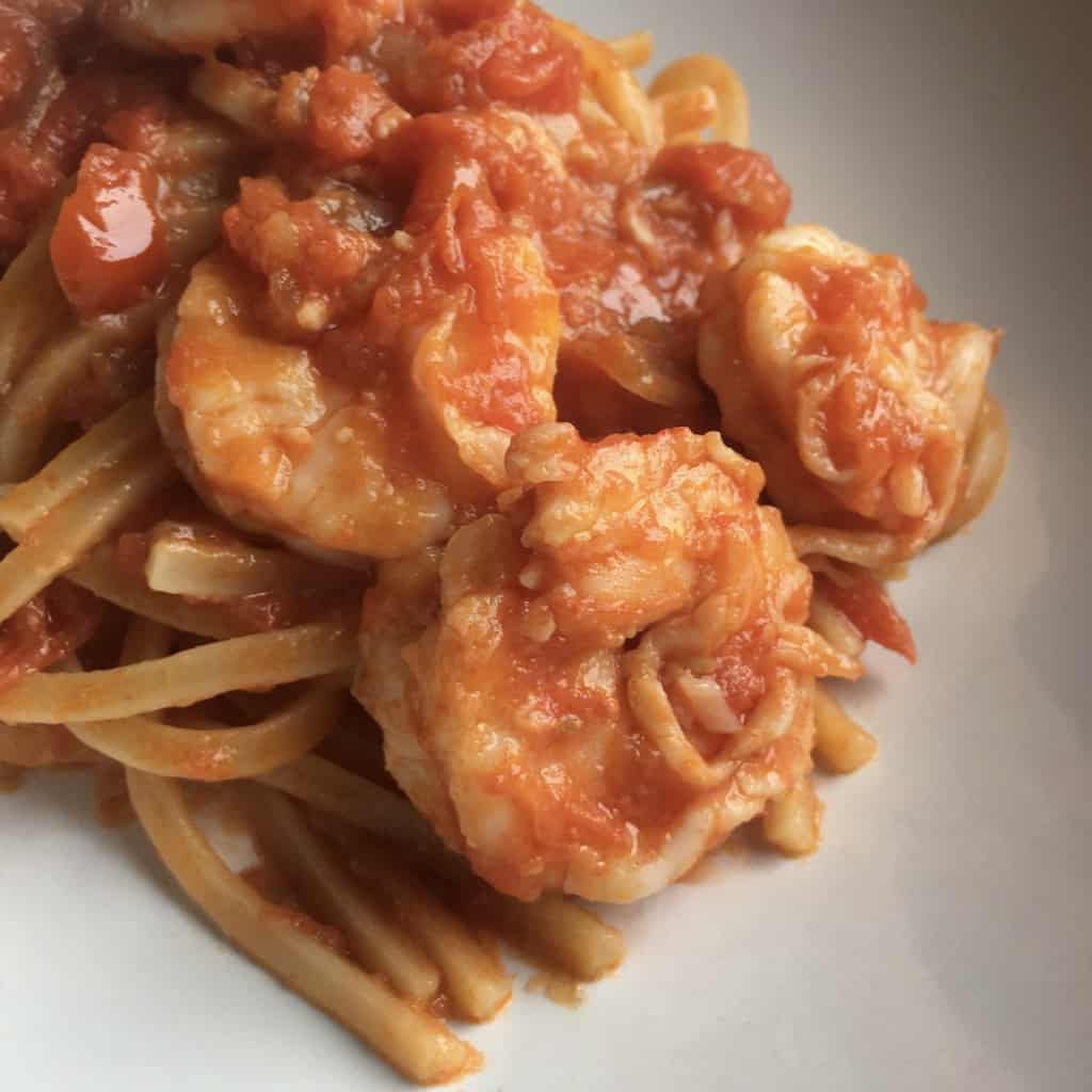 closeup of the shrimp pasta with large shrimp covered in a shrimp and tomato sauce