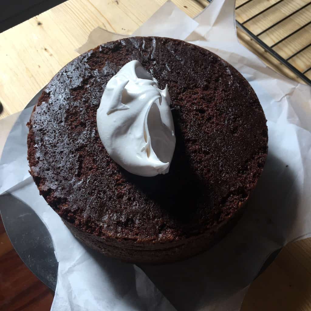 Dollop of fluffy homemade and hand-whipped 7-minute frosting on devil's food cake.