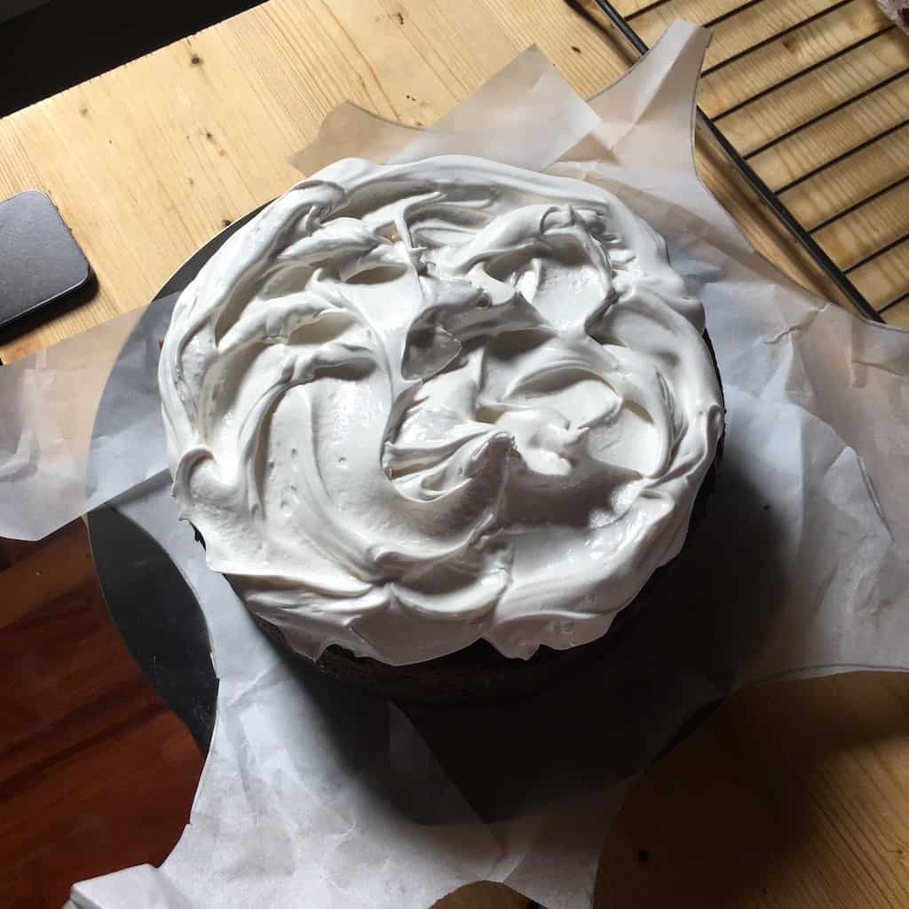 Frosted devil's food cake on parchment paper. 