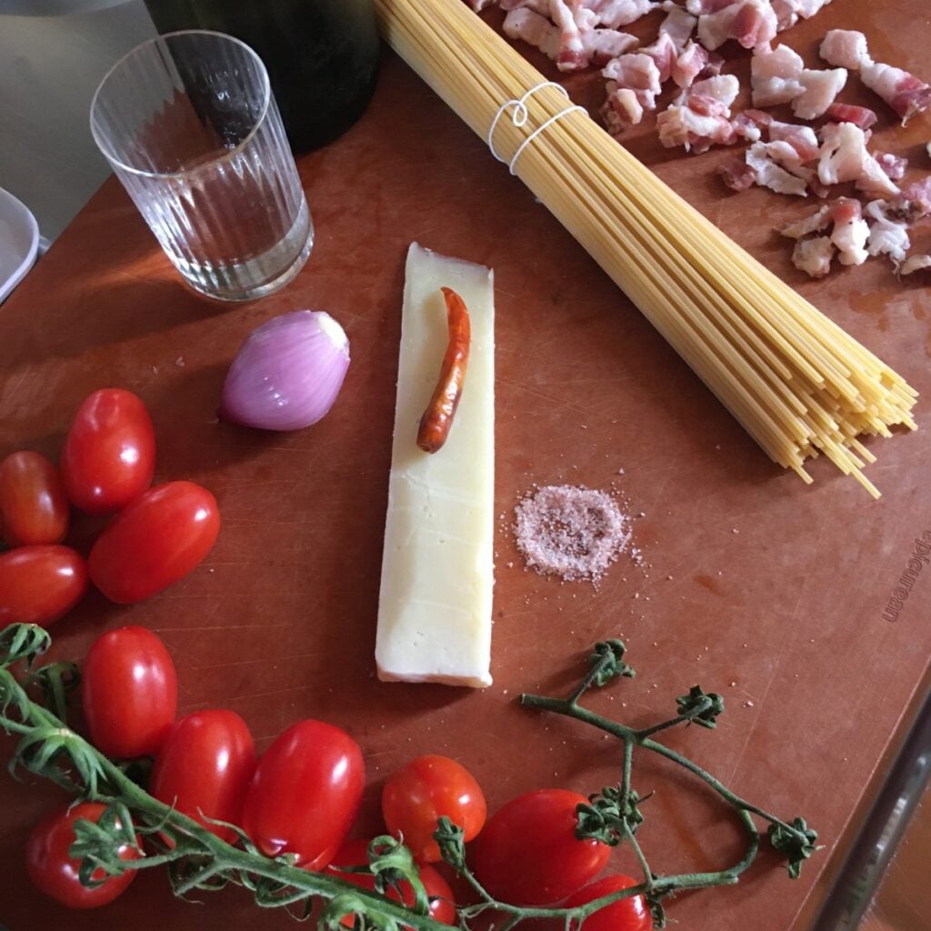 Raw amatriciana ingredients on a cutting board