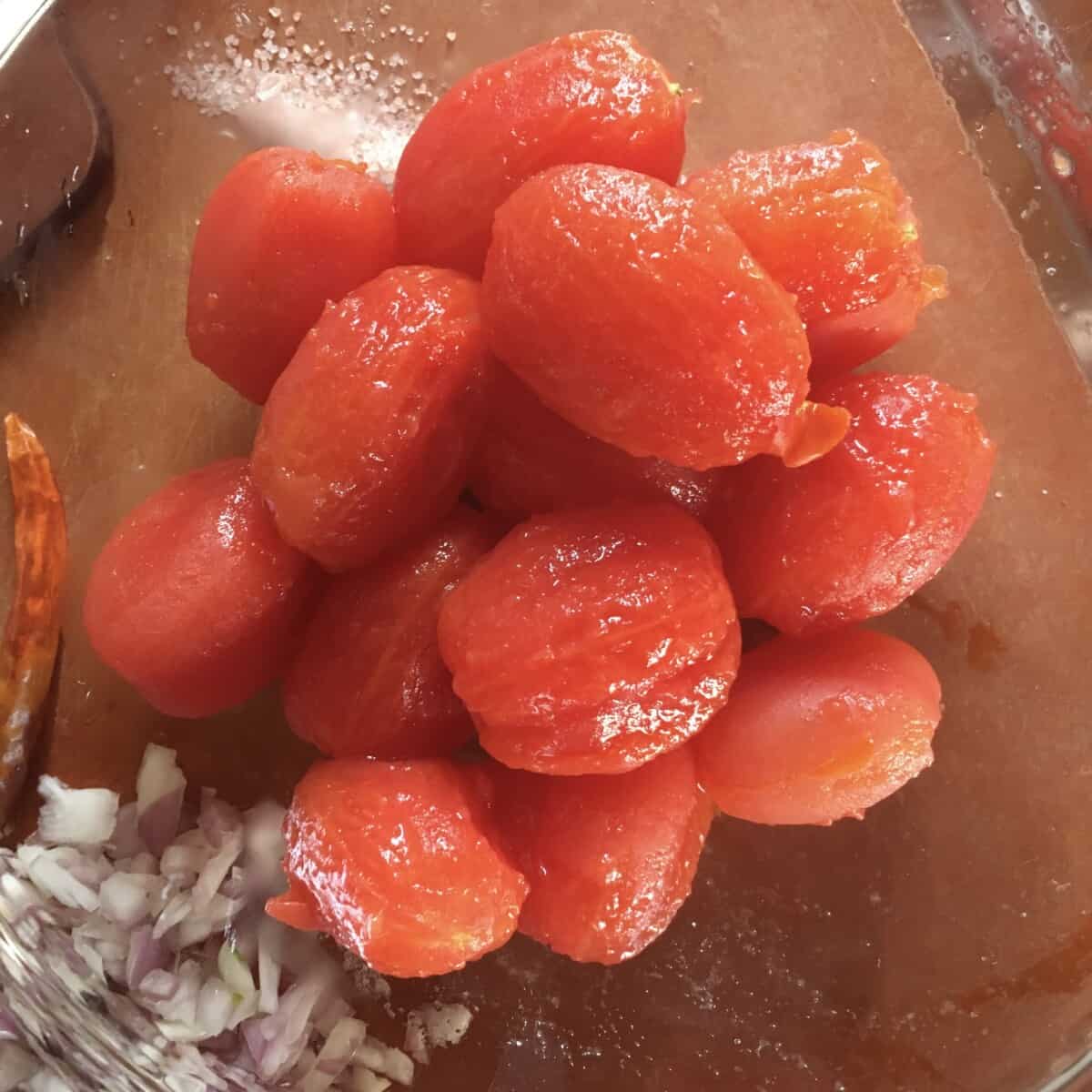 blanched and peeled grape Datterino tomatoes in a bowl