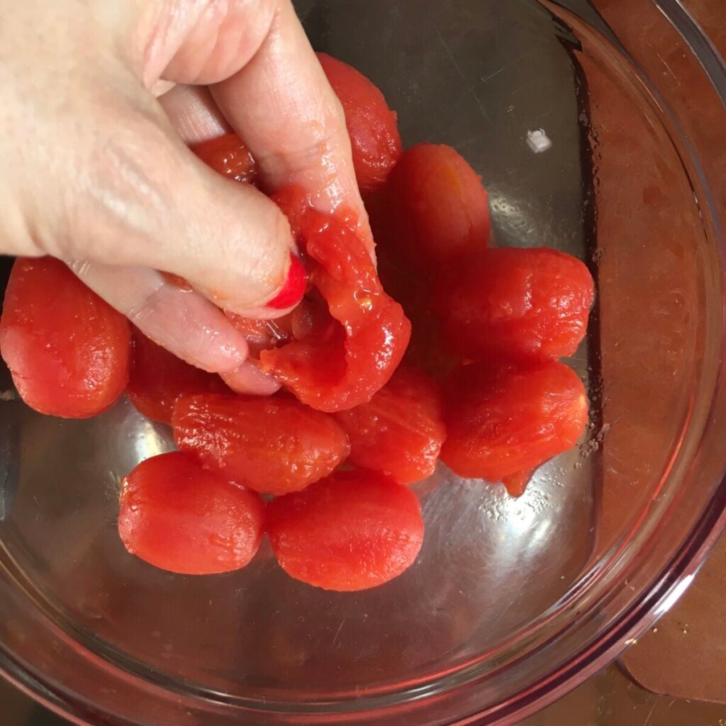 Peeling grape tomatoes for authentic amatriciana sauce