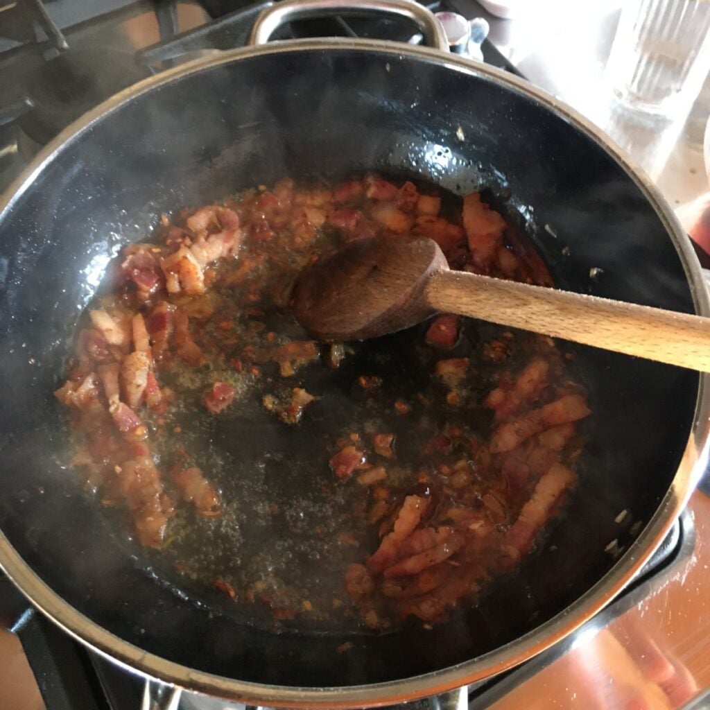 Deglazing pancetta with white wine for amatriciana sauce