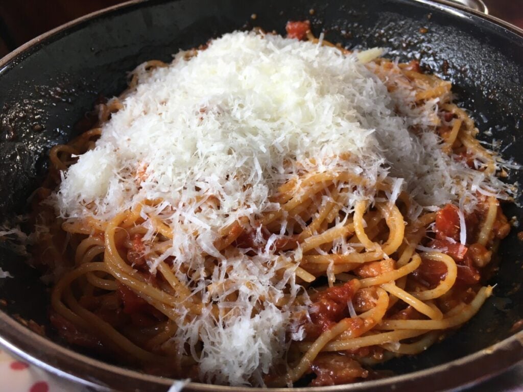 Pecorino Romano covered pasta all'amatriciana ready to toss