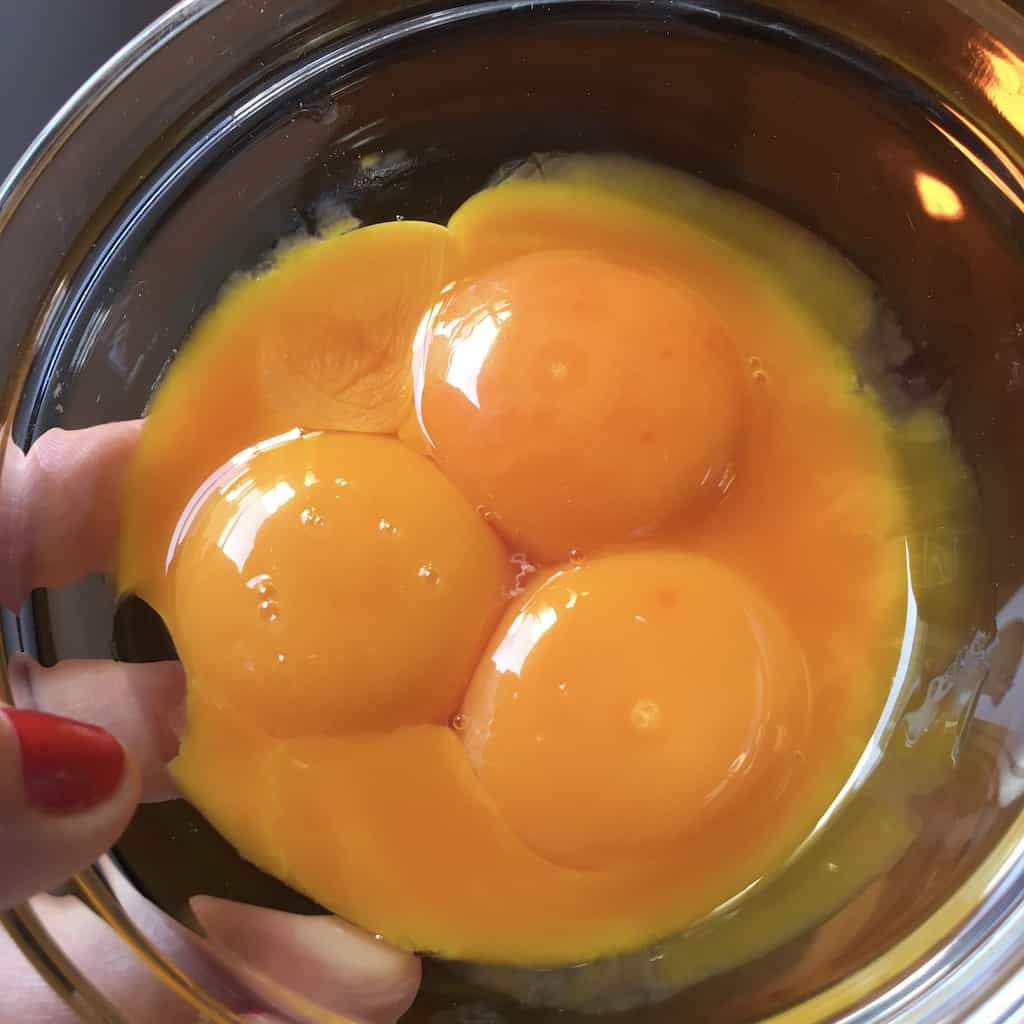 Egg yolks in a bowl separated from the whites.