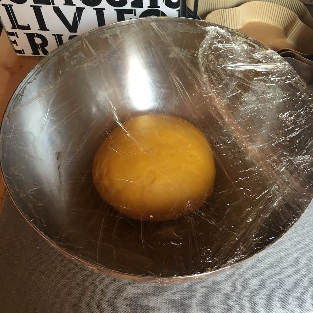 rising colomba dough covered in plastic wrap