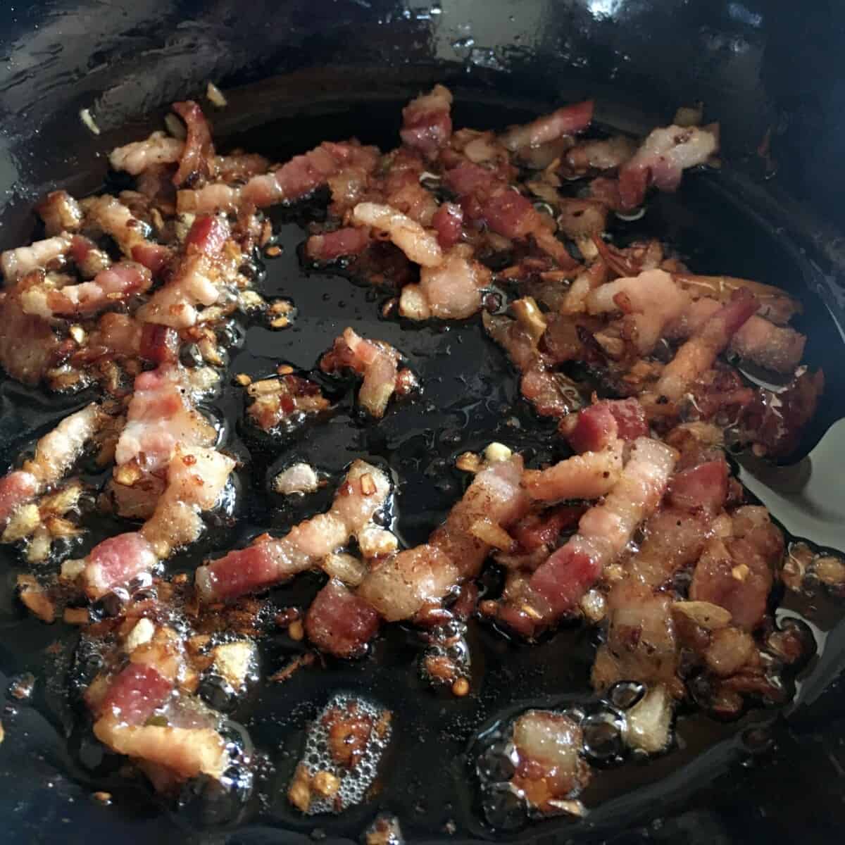 pancetta matchsticks frying in the skillet with shallots