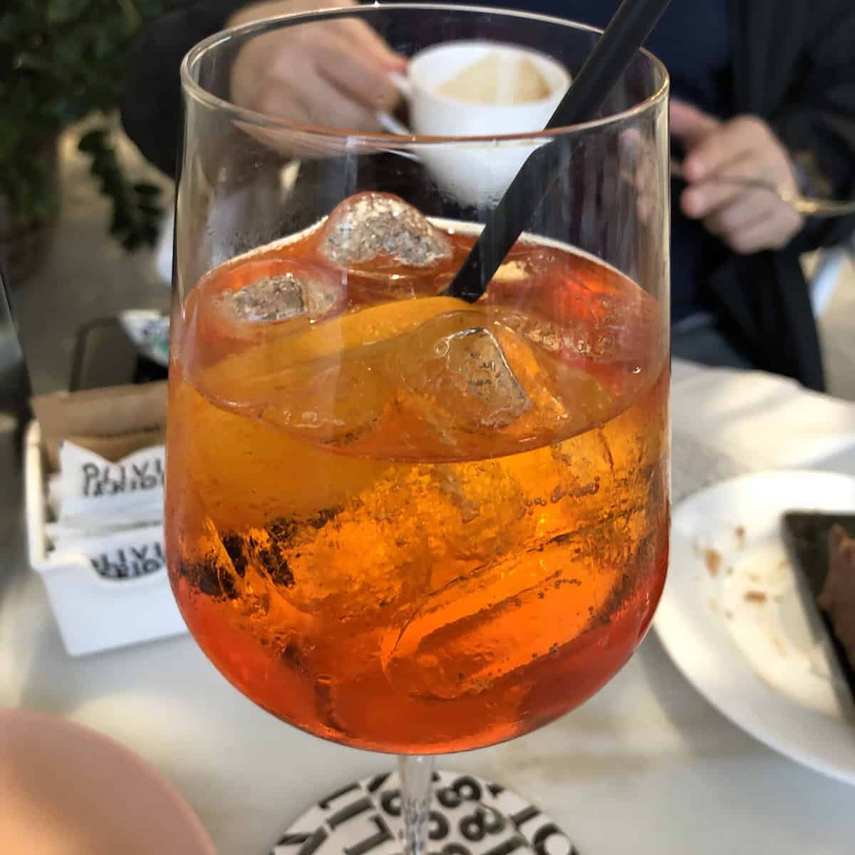 At our table in having classic Italian aperitivo at Olivieri 1882 in Arzignano, Italy when going to pick up our Easter Colomba di Pasqua (Italian easter dove bread) and a cappuccino.