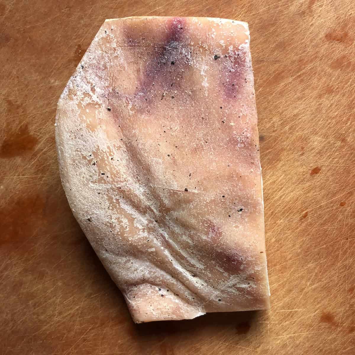 Whole guanciale cured pork jowl with skin from Abruzzo Italy, traditional Italian meat for pasta amatriciana and guanciale recipes.
