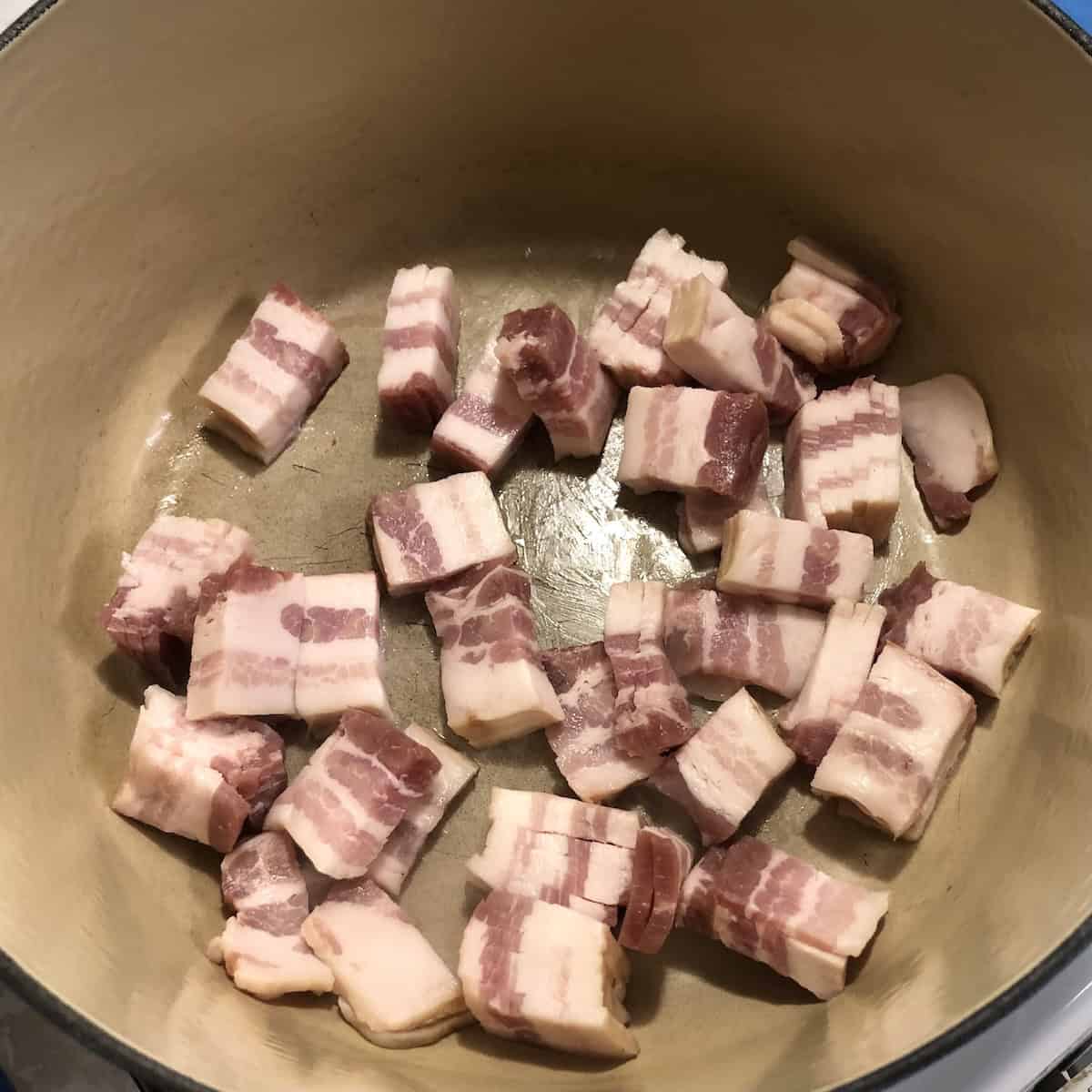Thick cut bacon chopped and cooking in Le Creuset dutch oven, guanciale (last resort) substitute for amatriciana sauce recipe.
