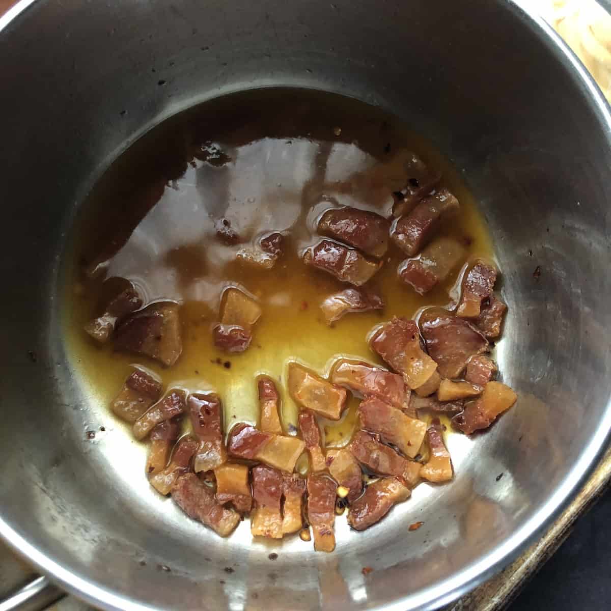 White wine added to cooked guanciale to deglaze pan, how to make amatriciana sauce step by step.