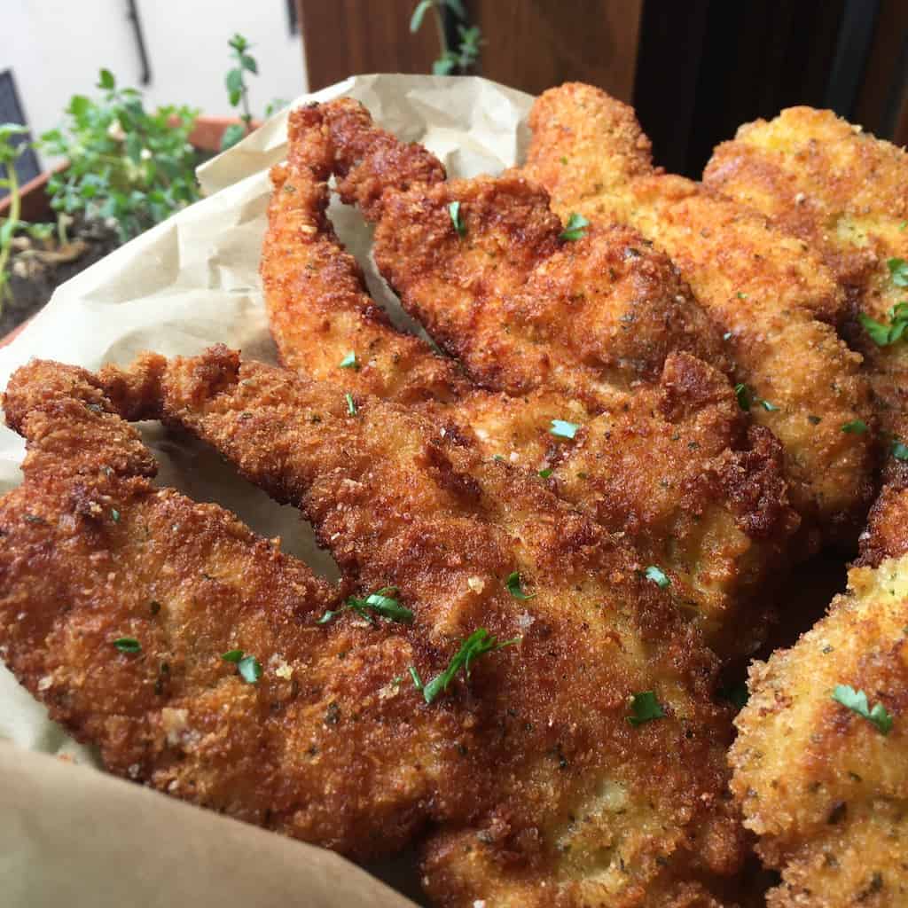 delicious crispy golden brown chicken cutlets with a panko parmigiano basil crust