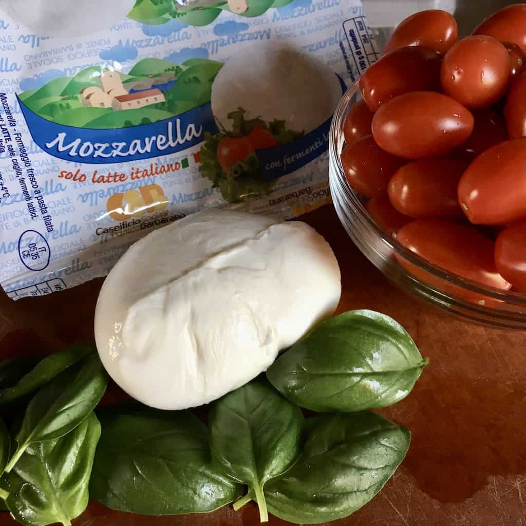 caprese salad ingredients on a cutting board