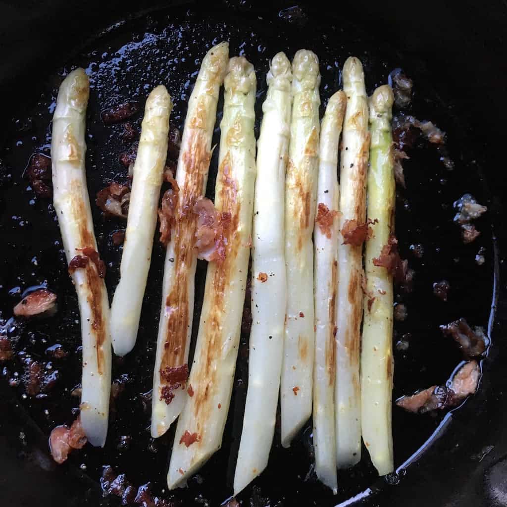 Italian white asparagus cooked in a cast iron skillet with bits of crispy prosciutto sprinkled on top (seasonal regional asparagus from Bassano Del Grappa in the veneto region.