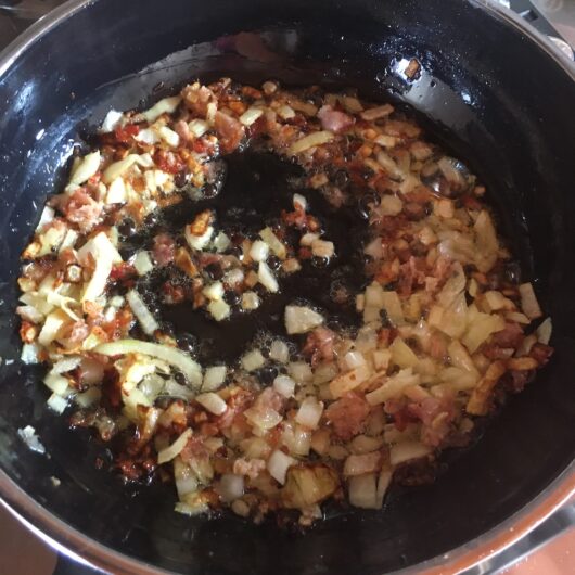 onions and prosciutto cooking in olive oil