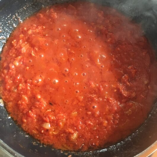 closuep of Prosciutto sugo red pasta sauce cooking