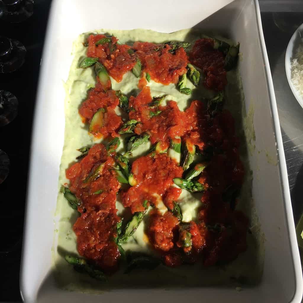prosciutto sugo layered on top of chopped asparagus