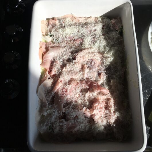 grated cheese covering the ham lightly