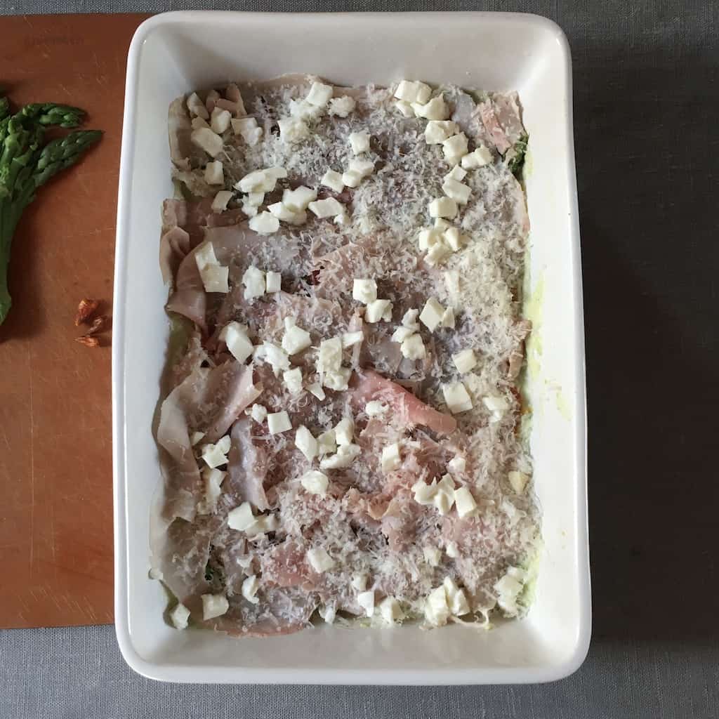 fresh mozzarella cubes covering the ham and grated cheese