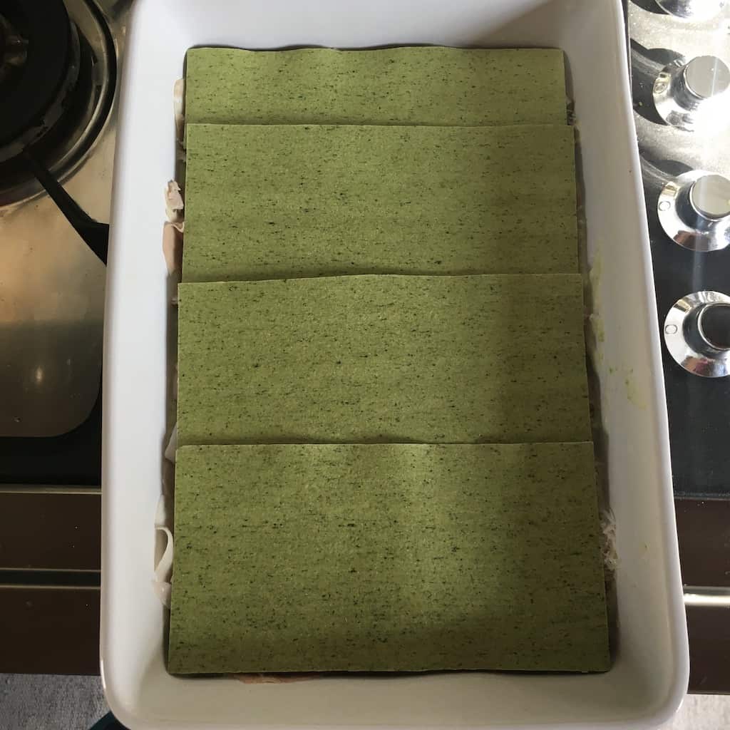 another layer of green spinach lasagna noodles covering the lasagna